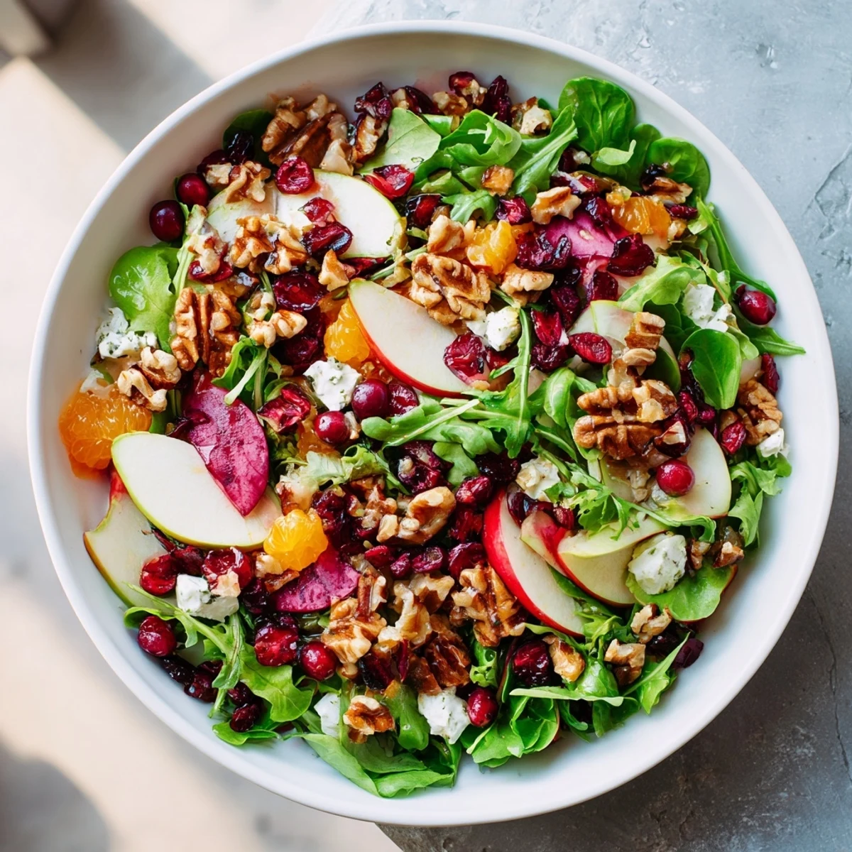 A beautiful bowl of Seasonal Cranberry and Walnut Celebration Salad, ready to serve and enjoy.
