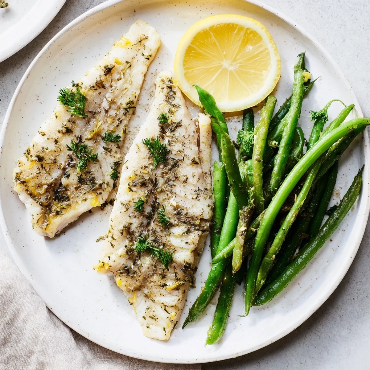Flavorful Sheet Pan Lemon Herb Tilapia and Green Beans, showcasing tender fish and crispy veggies, ideal for a quick dinner.