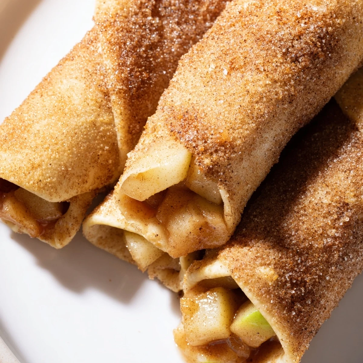 Golden-brown Apple Pie Roll-Ups fresh from the oven, ready to be enjoyed with a scoop of ice cream.