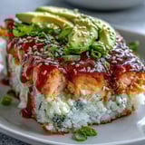 Golden-brown Spicy Salmon Sushi Bake scooped onto a roasted seaweed sheet, revealing fluffy rice and flaked fish layers.