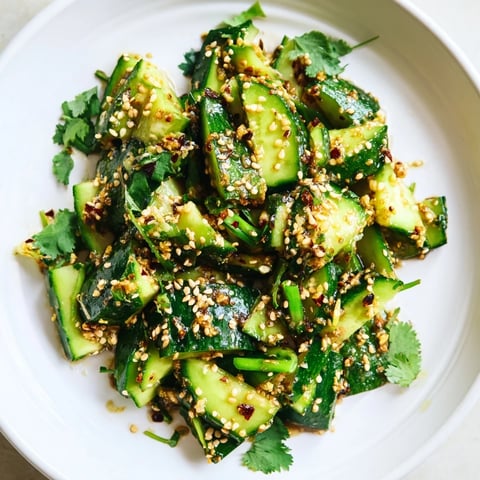 A vibrant, close-up of Chinese Spicy Smashed Cucumber Salad, showcasing the fresh, smashed cucumbers.