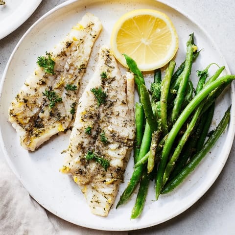 Flavorful Sheet Pan Lemon Herb Tilapia and Green Beans, showcasing tender fish and crispy veggies, ideal for a quick dinner.