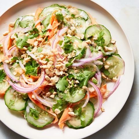 Crisp cucumbers and carrots combine in this refreshing Thai-Style Peanut Cucumber Salad, ready to enjoy.