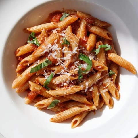Golden-brown Parmesan sprinkled across a bowl of freshly made Microwave Bowl Pasta, perfect for lunch.