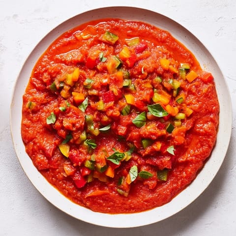 Vibrant veggie-loaded tomato pasta sauce, smooth and rich, ready to coat perfectly cooked pasta.