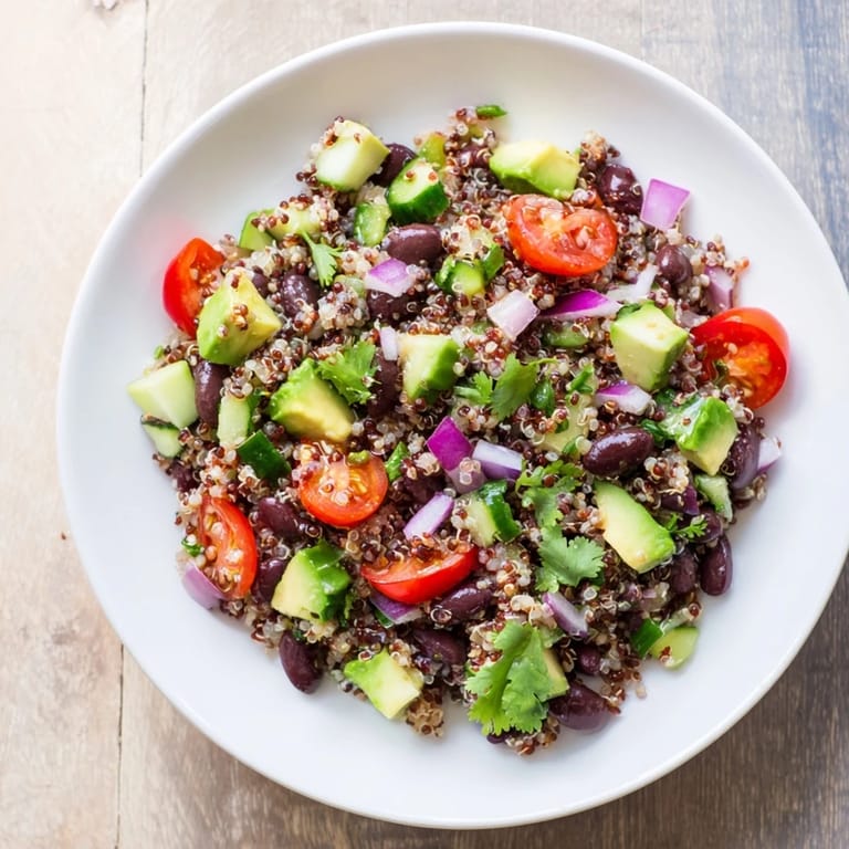 Colorful quinoa and black bean salad topped with fresh cilantro, a healthy and delicious meal.