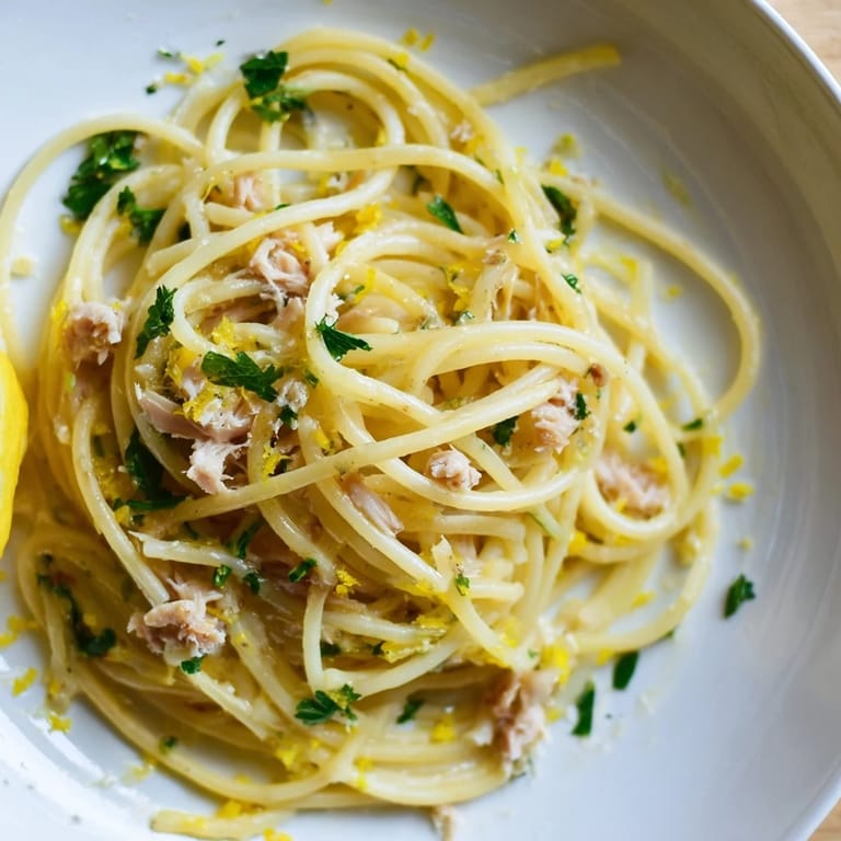 Close-up of perfectly cooked Lemon-Garlic Tuna Spaghetti, bursting with lemon and garlic aromas.