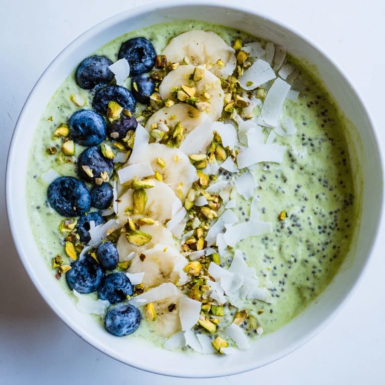 Beautifully green matcha overnight oats are topped with sliced banana, a delicious start to any morning.