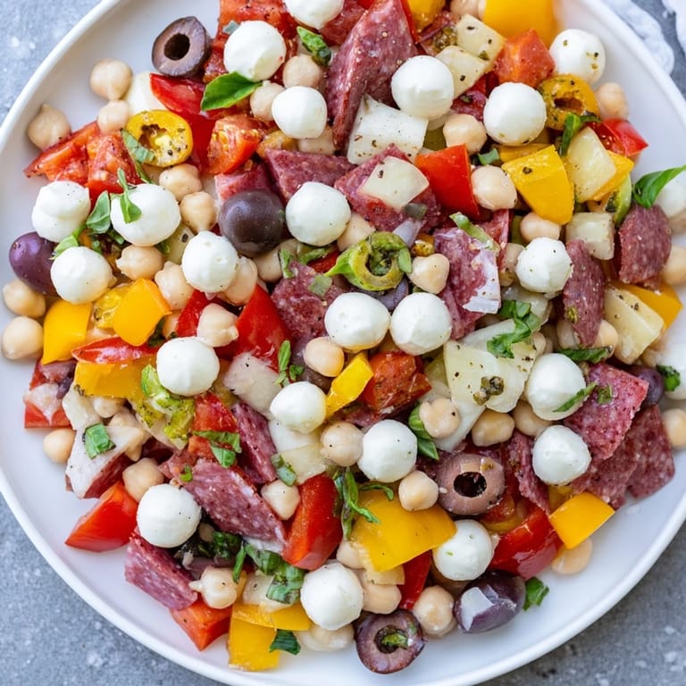 Serving suggestion for a Crunchy Antipasto Chopped Salad in a rustic bowl, garnished with fresh parsley and ready to enjoy.